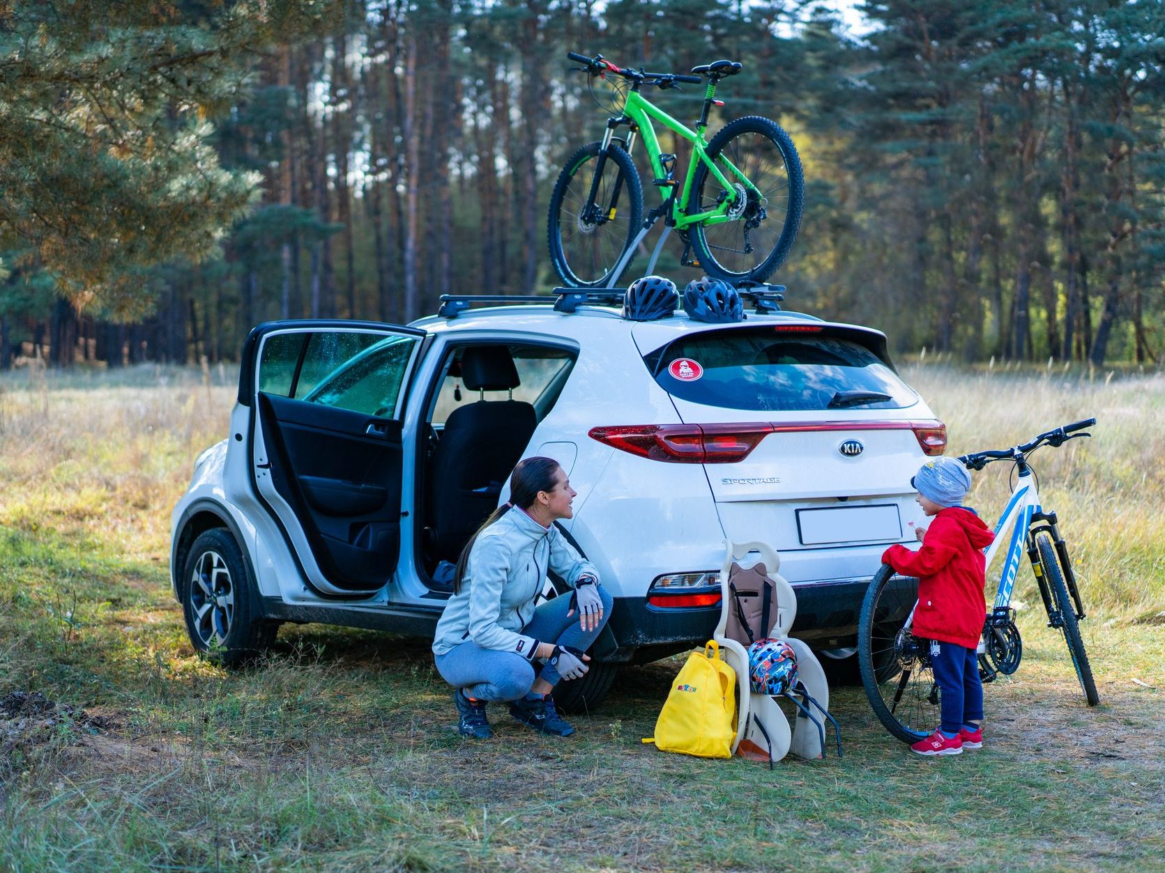 Family preparing for a road trip with bicycles and luggage