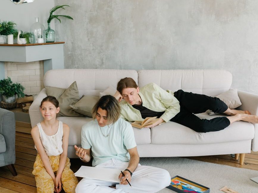Family relaxing together with games and activities in a comfortable living room.